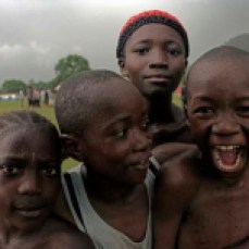 Boys play to the camera at Makeni Football stadium, Sierra Leone.