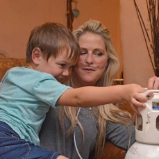 Express and Echo. Dying mum Jo Smith, sits with her son Rudey, 5, while he helps with her oxygen.